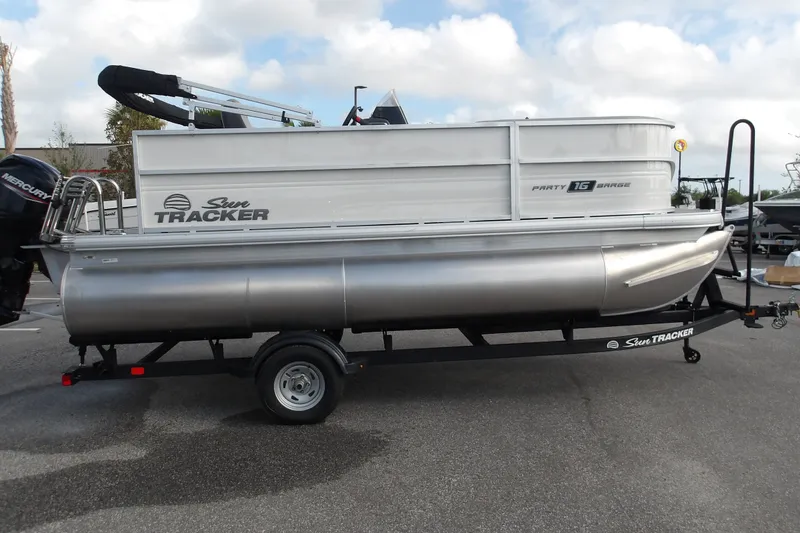 The Image of 2026 Sun Tracker Party Barge 16 DLX pontoon boat on trailer, side view. - 1