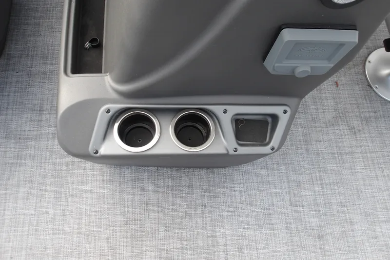 Slide: The Image of Cup holders and storage on 2026 Sun Tracker Party Barge 16 DLX boat console. - 19