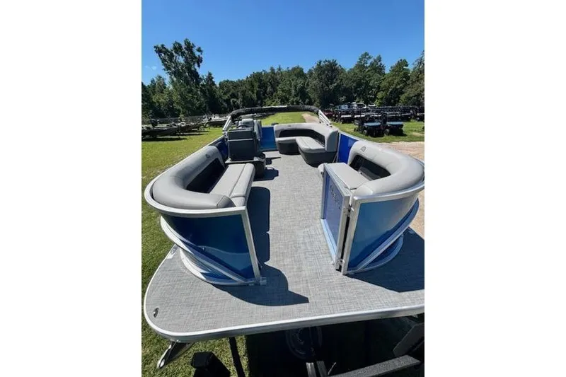 Slide: The Image of 2026 Sun Tracker Party Barge 16 DLX pontoon boat with spacious seating on a sunny day. - 6