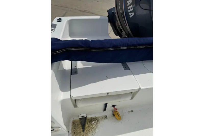Slide: The Image of 2011 Sea Hunt Triton 177 boat with Yamaha engine, featuring a covered seating area. - 10