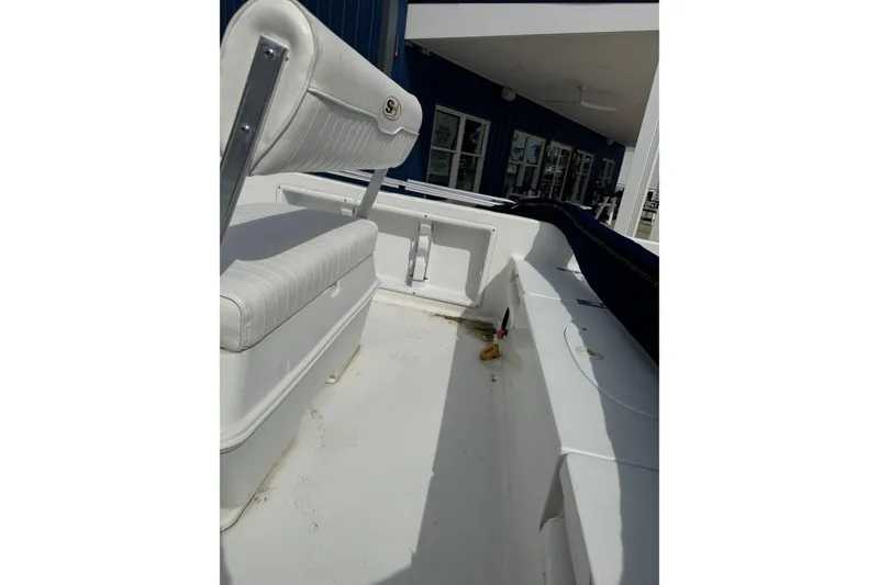 Slide: The Image of 2011 Sea Hunt Triton 177 boat interior with white seating and clean deck. - 11