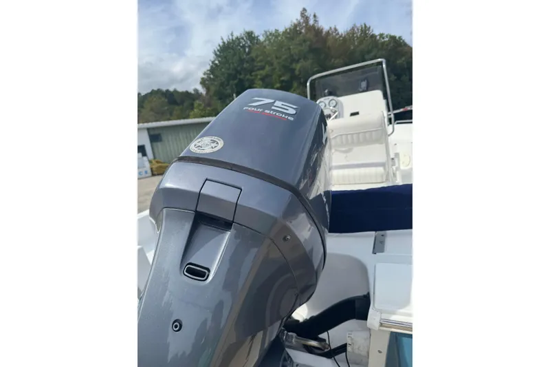 Slide: The Image of 2011 Sea Hunt Triton 177 boat with 75 horsepower outboard motor, docked outdoors. - 3