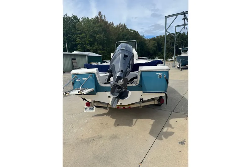 Slide: The Image of 2011 Sea Hunt Triton 177 boat with outboard motor, parked on concrete. - 4