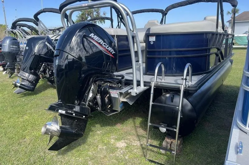 Slide: The Image of 2025 Sylvan Mirage 822 LZ pontoon boat with Mercury outboard engine, parked on grass. - 3