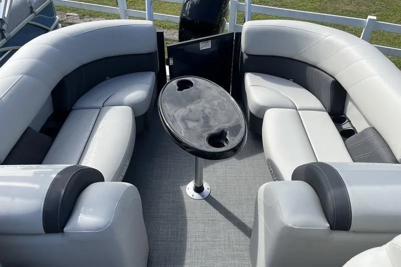 Slide: The Image of 2025 Sylvan Mirage 822 LZ boat interior with plush seating and central table. - 5