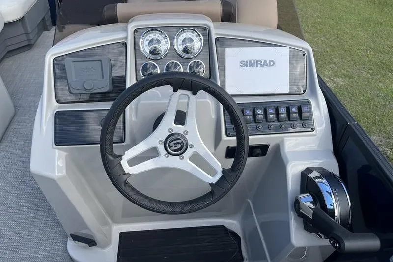 Slide: The Image of 2025 Sylvan Mirage 822 LZ boat dashboard with steering wheel and control panel. - 8