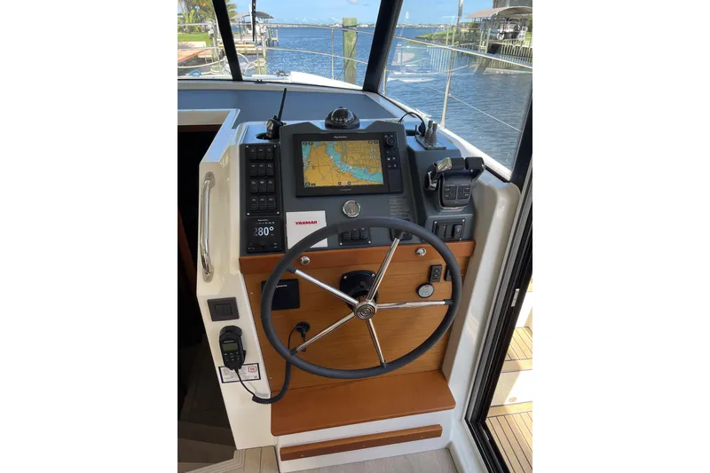 Slide: The Image of Helm of 2025 Beneteau Swift Trawler 41 Fly with navigation equipment and steering wheel. - 10