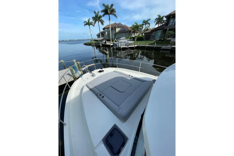 Slide: The Image of 2025 Beneteau Swift Trawler 41 Fly docked, featuring spacious deck and scenic waterfront view. - 17