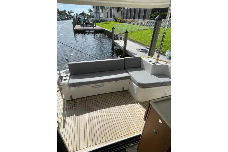 Slide: The Image of 2025 Beneteau Swift Trawler 41 Fly deck with seating, dockside view. - 20