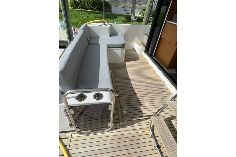 Slide: The Image of 2025 Beneteau Swift Trawler 41 Fly deck with seating and wooden flooring. - 21