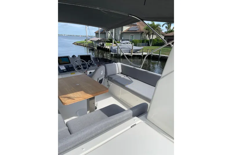 Slide: The Image of 2025 Beneteau Swift Trawler 41 Fly, featuring a spacious flybridge with seating and helm. - 24