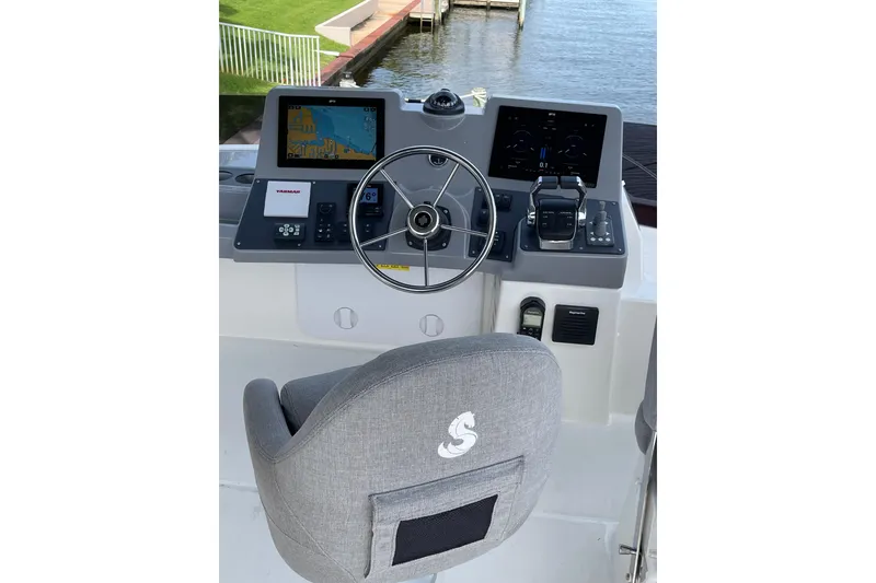 Slide: The Image of 2025 Beneteau Swift Trawler 41 Fly helm with navigation screens and steering wheel. - 26