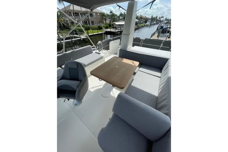 Slide: The Image of Flybridge seating area on 2025 Beneteau Swift Trawler 41 Fly, featuring a table and cushioned seats. - 29