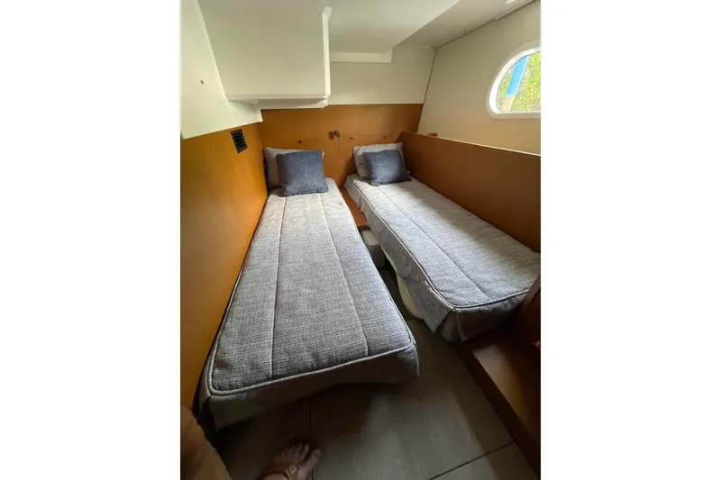 Slide: The Image of 2025 Beneteau Swift Trawler 41 Fly cabin with twin beds and modern design. - 33