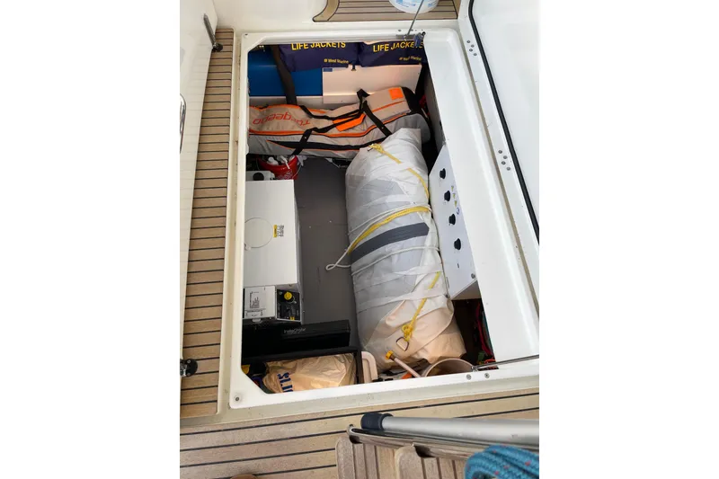 Slide: The Image of Storage compartment of 2025 Beneteau Swift Trawler 41 Fly with life jackets and equipment. - 39