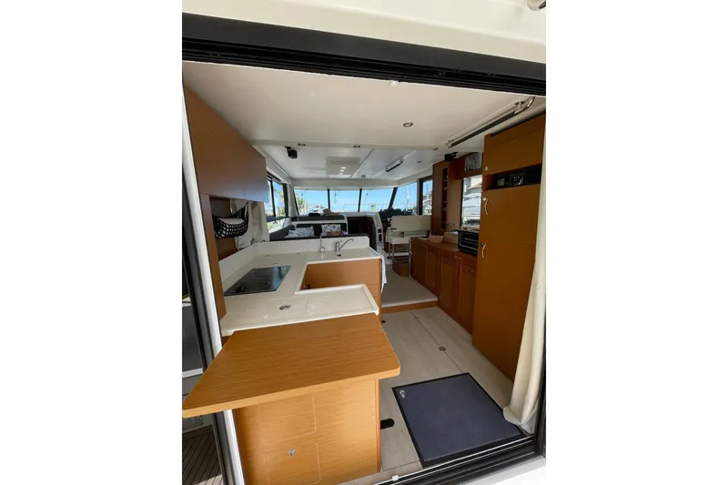 Slide: The Image of Interior view of 2025 Beneteau Swift Trawler 41 Fly, featuring modern kitchen and seating area. - 6