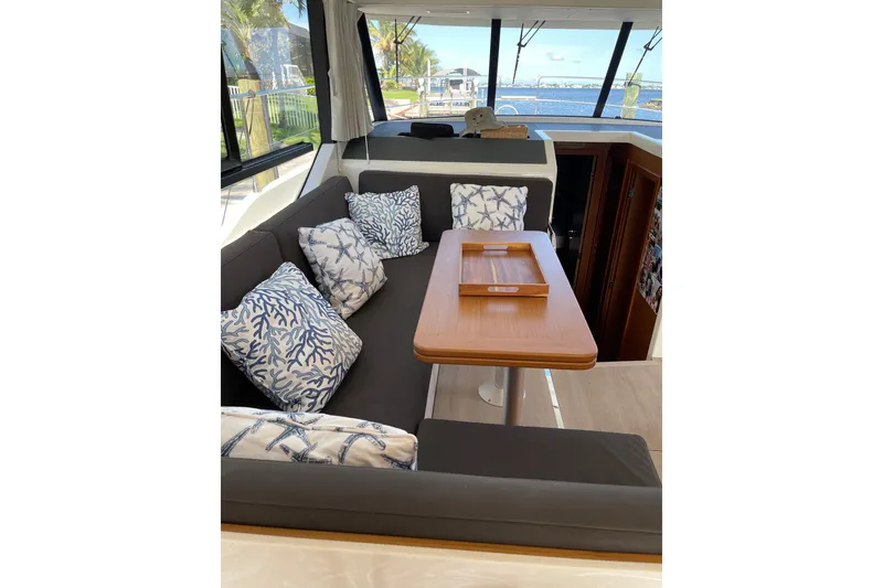 Slide: The Image of Interior of 2025 Beneteau Swift Trawler 41 Fly with cozy seating and nautical-themed cushions. - 9