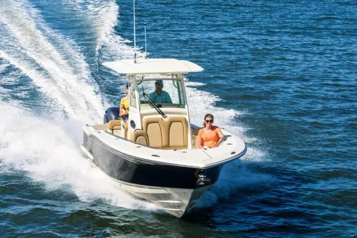 The Image of 2020 Scout 255 LXF boat with Yamaha engine on a trailer, parked outdoors. - 0