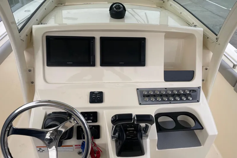 Slide: The Image of 2020 Scout 255 LXF boat dashboard with dual Garmin displays and Yamaha controls. - 15