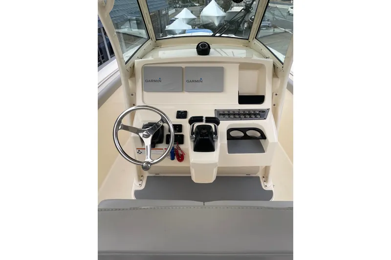 Slide: The Image of 2020 Scout 255 LXF boat dashboard with Garmin displays and steering wheel. - 16