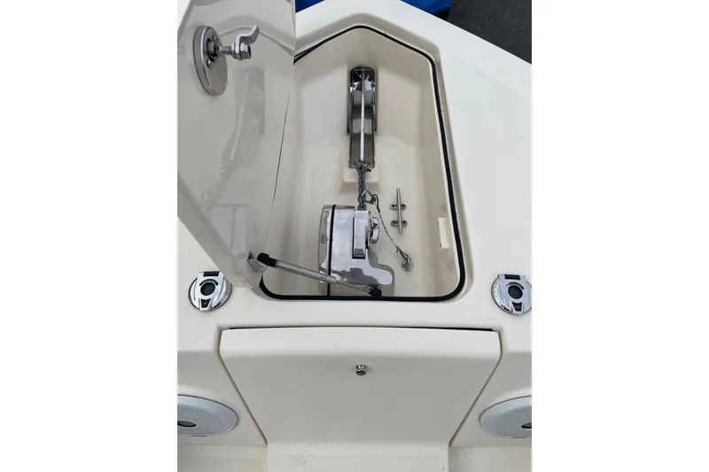 Slide: The Image of Open anchor compartment on 2020 Scout 255 LXF boat, showcasing anchor and chain storage. - 18