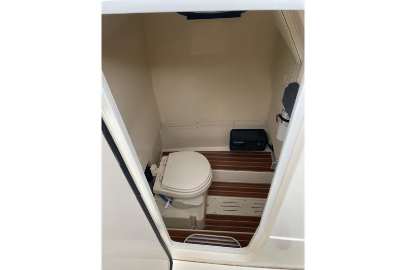 Slide: The Image of 2020 Scout 255 LXF boat interior with compact marine toilet. - 20