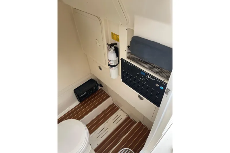 Slide: The Image of 2020 Scout 255 LXF interior with control panel, fire extinguisher, and wooden flooring. - 21