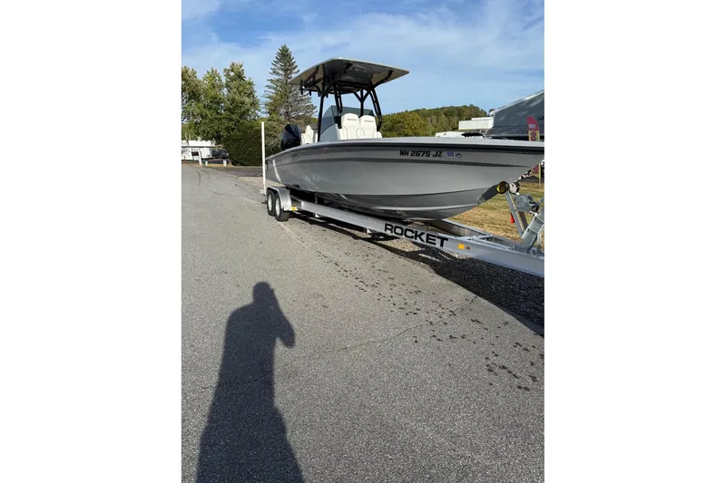 Slide: The Image of 2026 Concept 27' CC boat on trailer, parked outdoors under clear sky. - 0