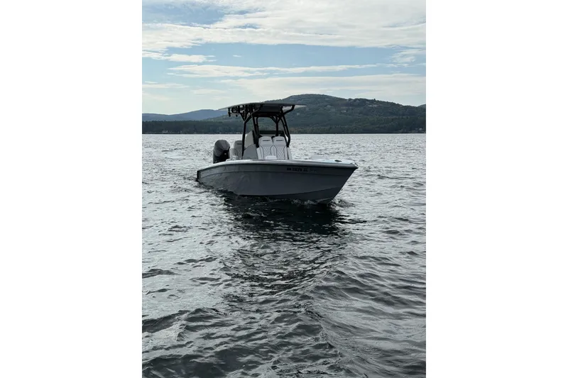Slide: The Image of 2026 Concept 27' CC boat on a calm lake with scenic mountain backdrop. - 1