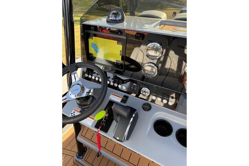 Slide: The Image of 2026 Concept 27' CC boat dashboard with steering wheel, navigation screen, and control panel. - 10