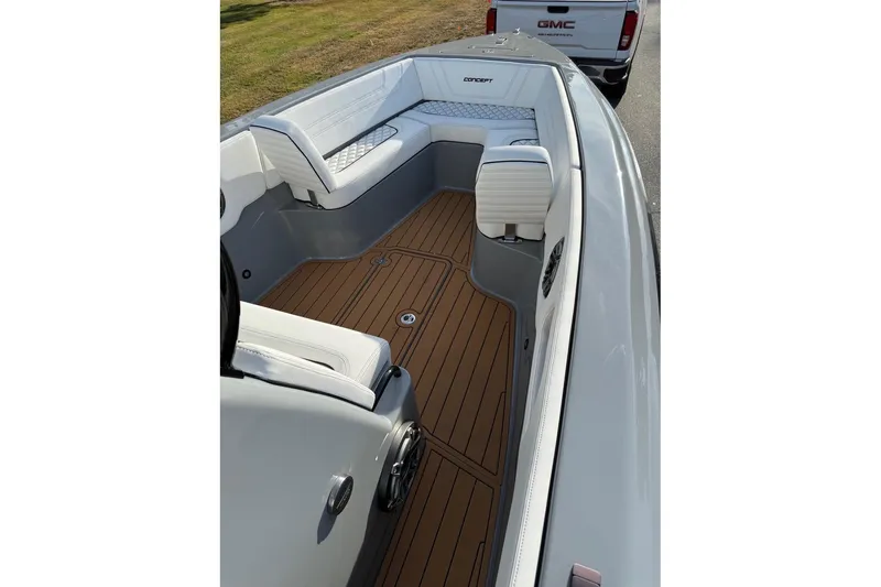 Slide: The Image of 2026 Concept 27' CC boat interior with sleek white seating and wood-style flooring. - 14