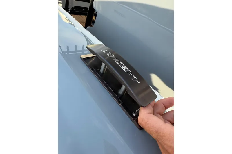 Slide: The Image of Hand adjusting cleat on 2026 Concept 27' CC boat deck. - 16