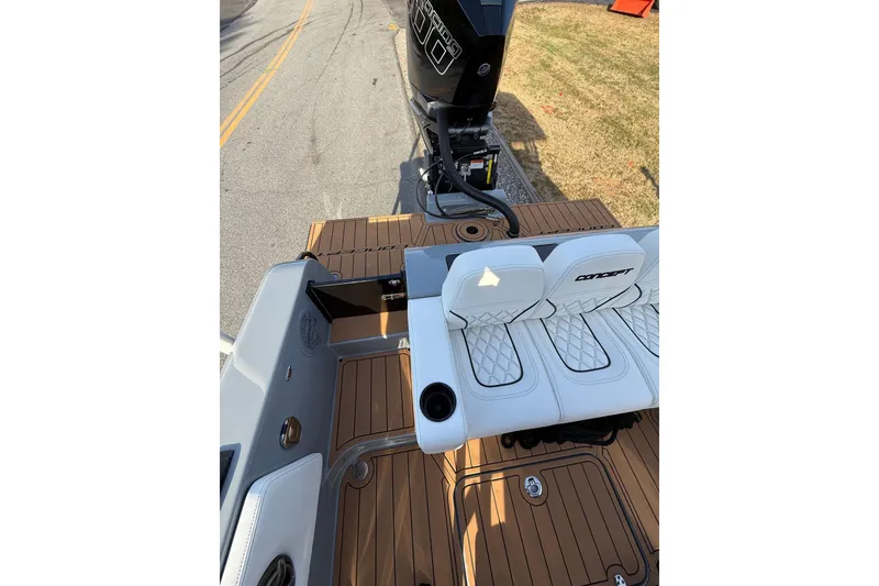 Slide: The Image of 2026 Concept 27' CC boat with white seating and teak flooring, featuring a powerful outboard motor. - 18