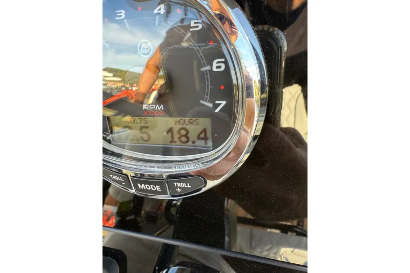 Slide: The Image of Close-up of a Concept 27' CC 2026 boat tachometer showing 18.4 hours and 5 volts. - 19