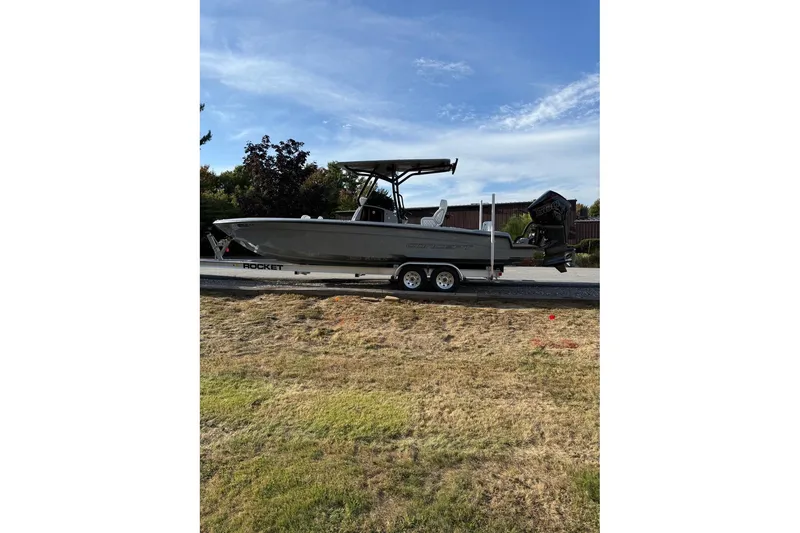 Slide: The Image of 2026 Concept 27' CC boat on trailer, parked on grass under blue sky. - 5