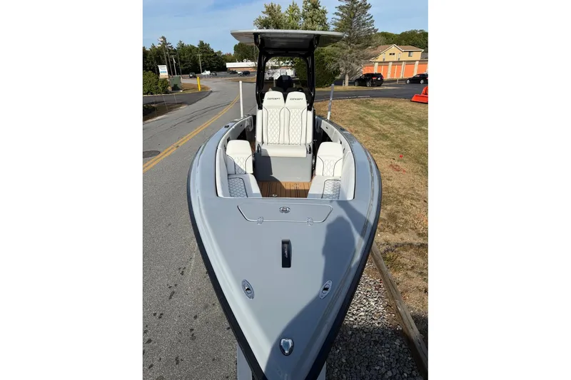 Slide: The Image of 2026 Concept 27' CC boat with sleek design and modern seating, parked on roadside. - 7