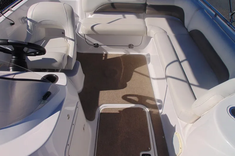 Slide: The Image of 2013 Hurricane SunDeck Sport 201 IO boat interior with white seating and steering console. - 13