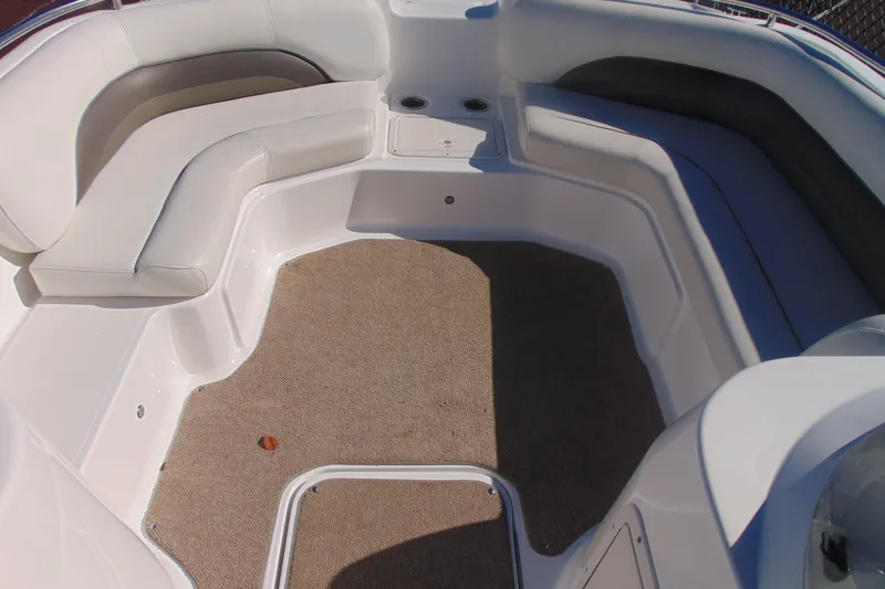 Slide: The Image of 2013 Hurricane SunDeck Sport 201 IO boat interior with cushioned seating and carpeted floor. - 15