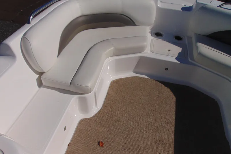 Slide: The Image of 2013 Hurricane SunDeck Sport 201 IO boat interior with white seating and carpeted floor. - 17
