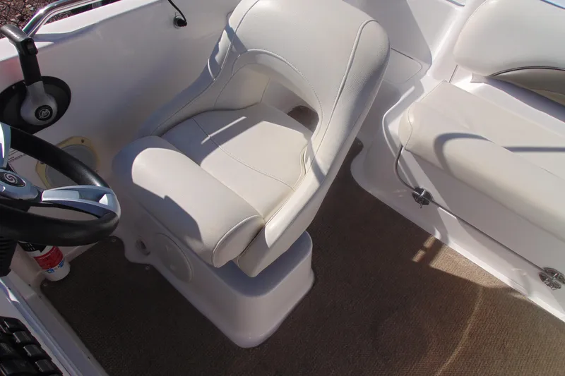 Slide: The Image of 2013 Hurricane SunDeck Sport 201 IO boat interior with steering wheel and seating. - 19