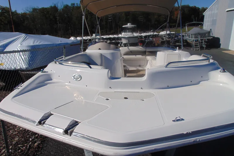 Slide: The Image of 2013 Hurricane SunDeck Sport 201 IO boat with spacious deck and canopy. - 2
