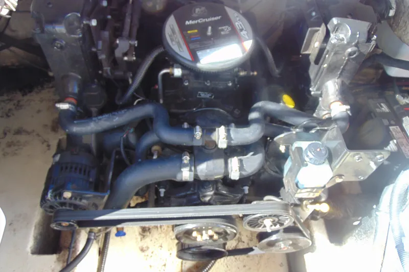 Slide: The Image of Engine of a 2013 Hurricane SunDeck Sport 201 IO boat, featuring MerCruiser components. - 21