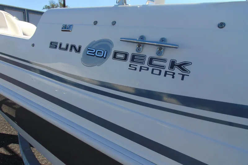Slide: The Image of 2013 Hurricane SunDeck Sport 201 IO boat side view with model branding. - 6