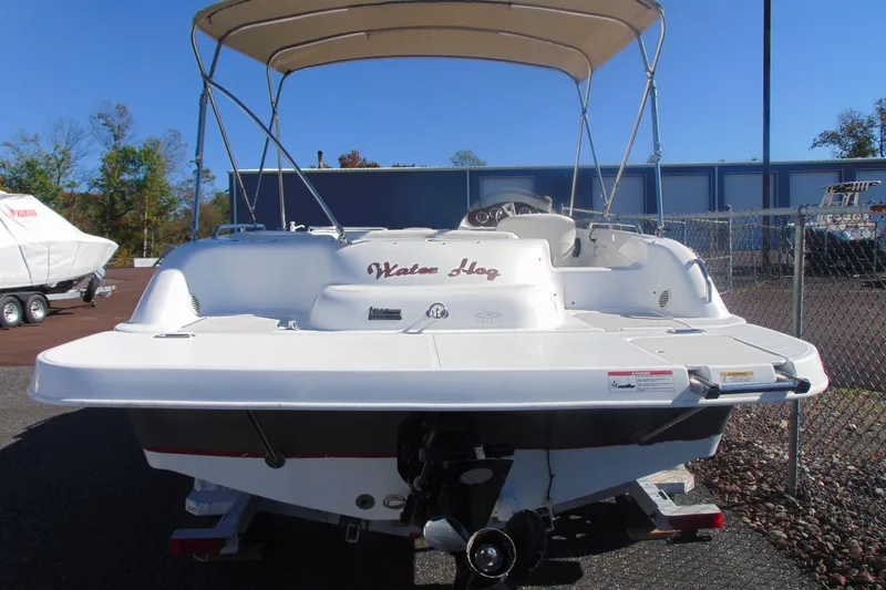 Slide: The Image of 2013 Hurricane SunDeck Sport 201 IO boat with canopy, parked outdoors. - 8
