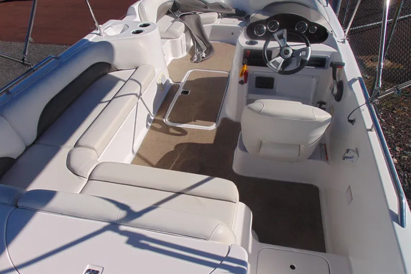 Slide: The Image of 2013 Hurricane SunDeck Sport 201 IO boat interior with seating and steering console. - 9