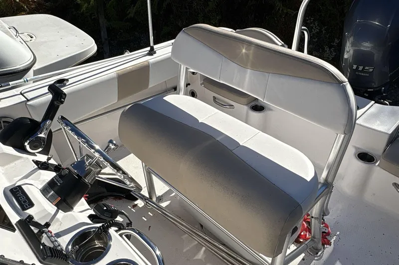 Slide: The Image of 2019 Robalo R180 Center Console boat interior with steering wheel and seating. - 11