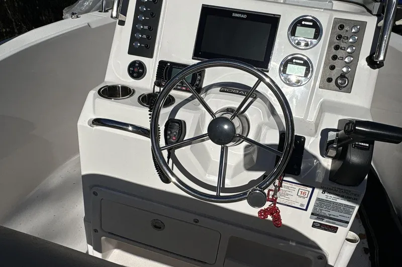 Slide: The Image of 2019 Robalo R180 Center Console dashboard with steering wheel and controls. - 13