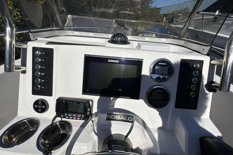 Slide: The Image of 2019 Robalo R180 Center Console dashboard with Simrad display and Yamaha gauges. - 15