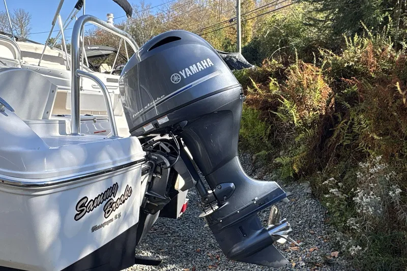 Slide: The Image of 2019 Robalo R180 Center Console with Yamaha outboard motor, parked on gravel. - 7