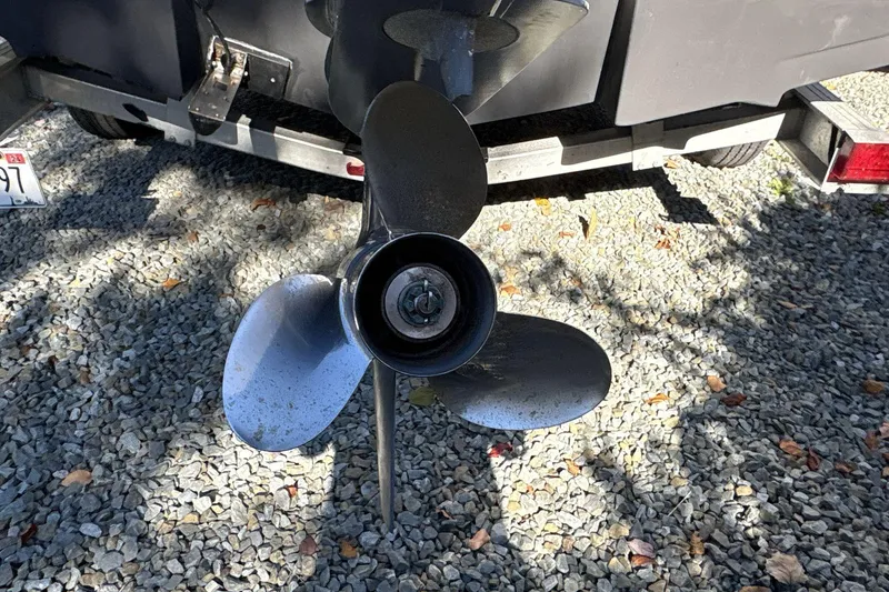 Slide: The Image of Propeller of a 2019 Robalo R180 Center Console boat on gravel surface. - 8